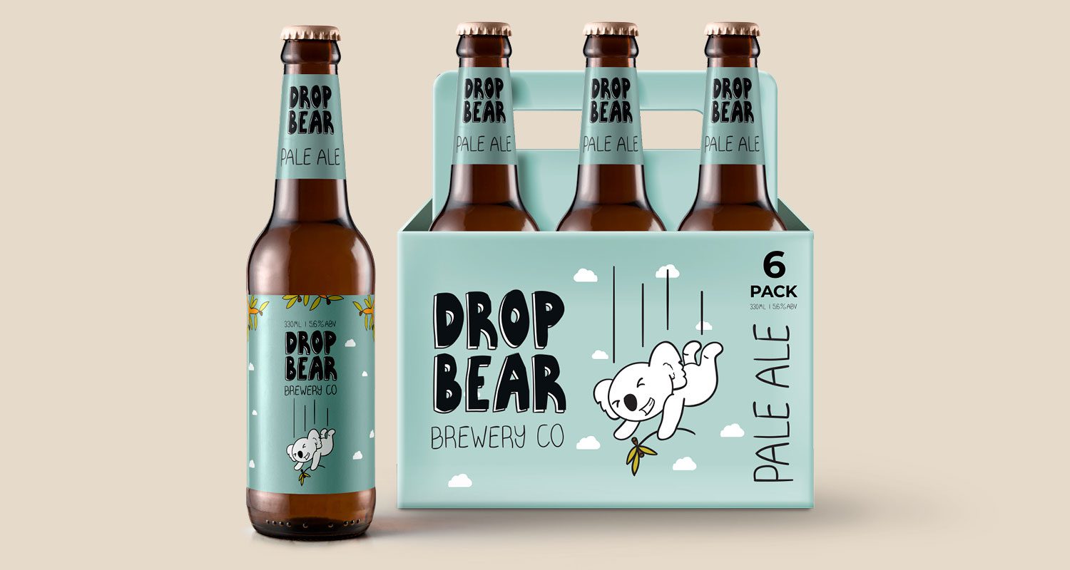 Photograph of a six-pack of beer with a single bottle placed beside it. The labels feature illustrations of a playful drop bear character falling through the sky, with a mischievous expression. The setting has a simple, neutral background.